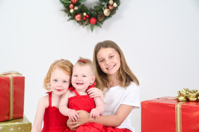 Three sisters posing for a Christmas photo