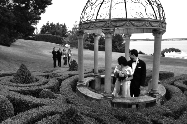 Bride and groom in outdoor pergola