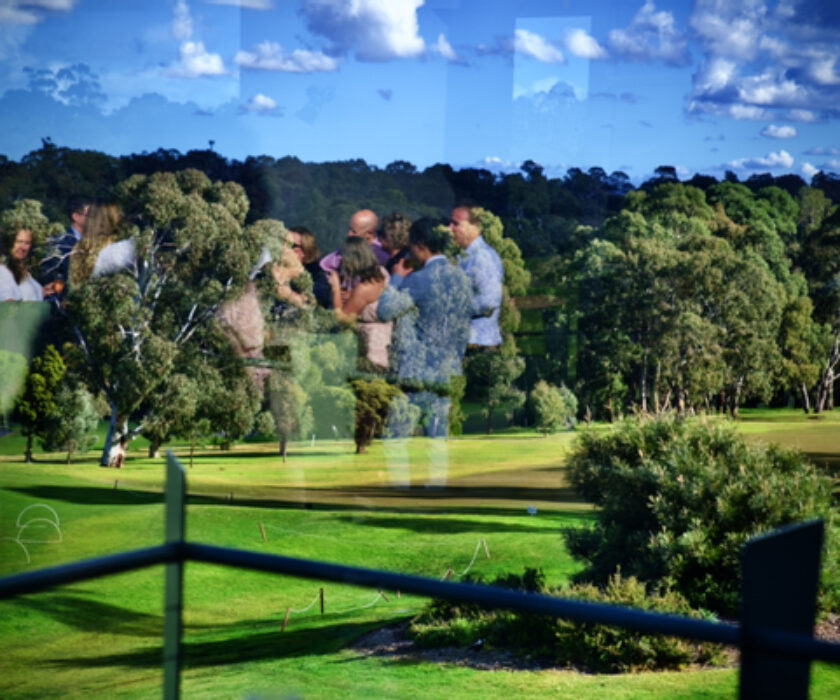 Reflection of wedding party in window